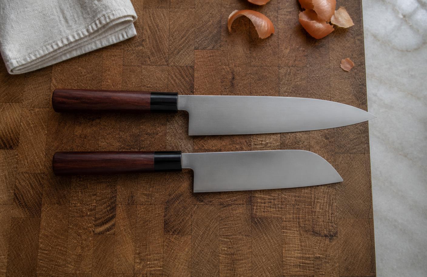 Gyuto and santoku chef knives compared on an end-grain cutting board